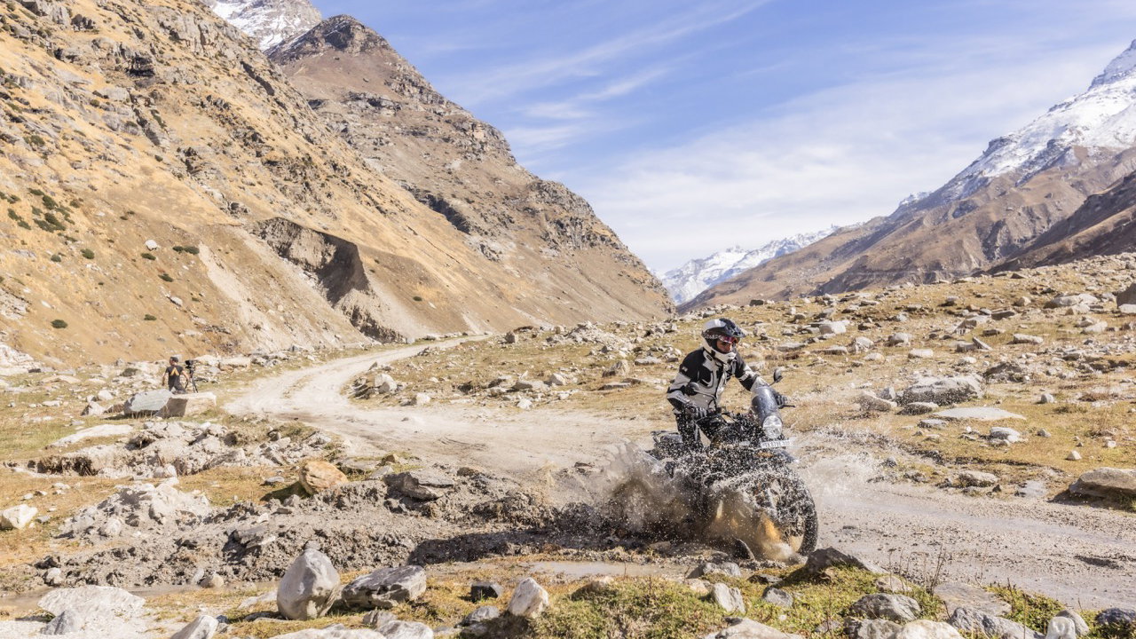A motorcycle riding through a water splash 